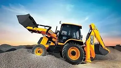 Backhoe loader with its front bucket raised on a gravel site