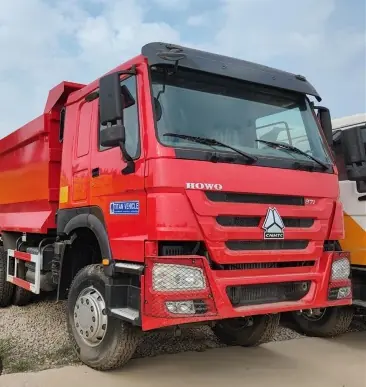 Red HOWO dump truck, front view