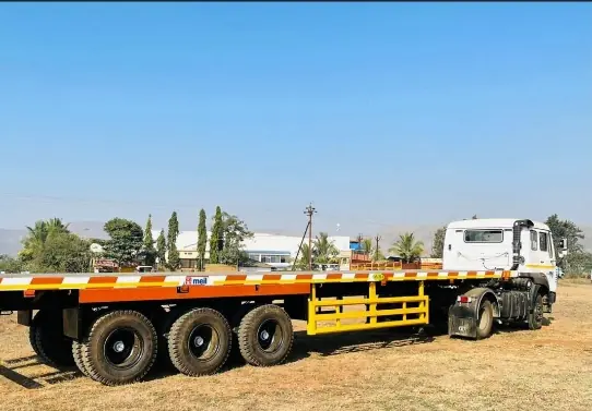 Flatbed trailer hitched to a white truck