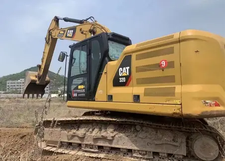 Caterpillar 320 excavator on a cleared site